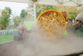 Cocinando en un enorme recipiente durante el evento Feed the 5000 de Feedback
