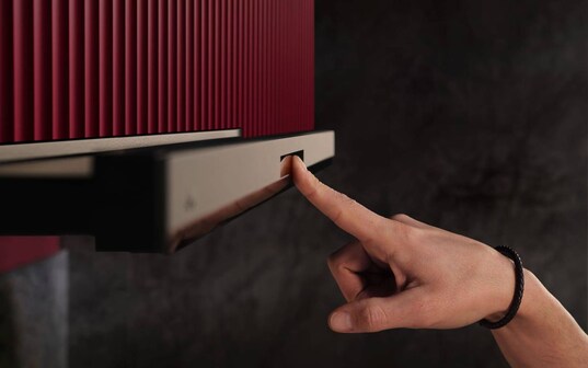 A finger is touching a cooker hood.
