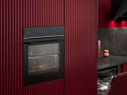 An oven in a red kitchen.